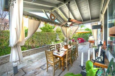 Rear yard showing gabled patio cover and fan