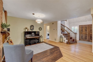 Living room featuring wood finished floors, stairw