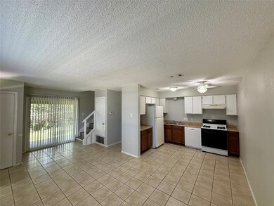Kitchen with white appliances, light countertops,