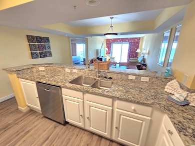 Kitchen with white cabinetry, dishwasher, sink, an