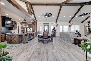 Dining space featuring beam ceiling, ceiling fan, 