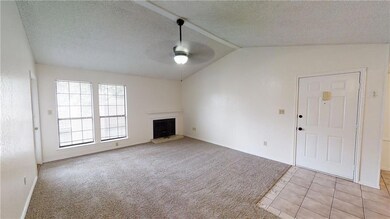 Unfurnished living room featuring ceiling fan, lo