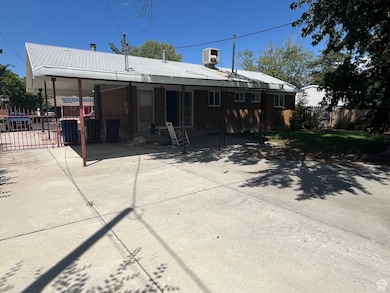 Rear view of property with brick siding and a patio