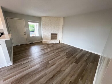Unfurnished living room featuring a stone firepla
