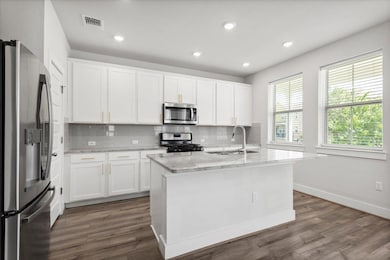 Kitchen with stainless steel appliances, a sink, 