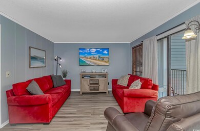 Living area featuring ornamental molding and wood finished floors