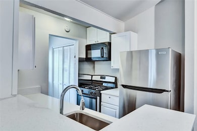 Kitchen featuring stainless steel appliances, a s