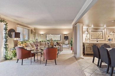 The living room is open to the dining room and the wet bar, creating a wonderful space for entertaining.