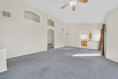 Unfurnished living room with arched walkways, high