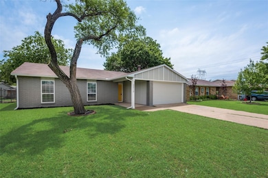Ranch-style house with driveway, a front lawn, an attached garage, and brick siding