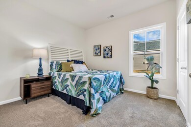 Carpeted bedroom with baseboards