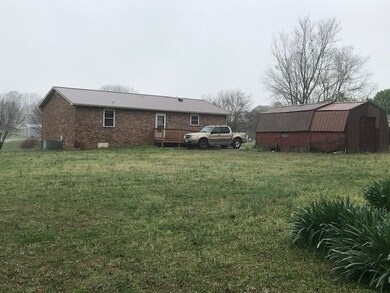 LARGE BACKYARD! also has storage building with shelving!