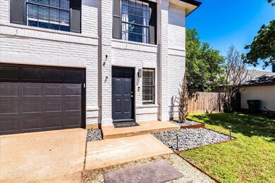 View of exterior entry featuring brick siding, fe