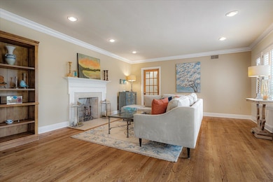 Living room featuring hardwood floors, a gas firep