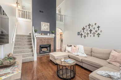 Living room featuring a high vaulted ceiling, oak 