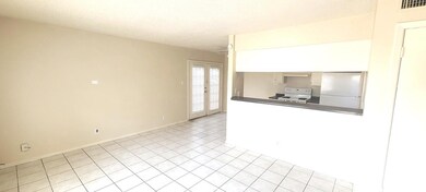 Kitchen with white appliances, french doors, ligh