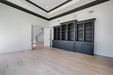 Empty room featuring light wood-type flooring, vis