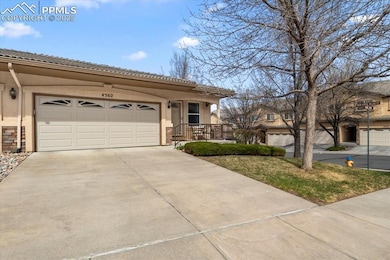 View of front of property with a garage, driveway,