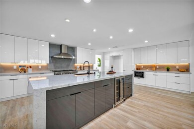 Kitchen with modern cabinets, wall chimney range h