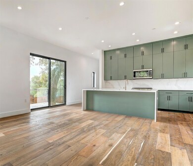 Kitchen with green cabinets, stainless steel micr