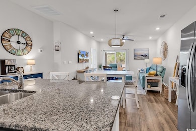 Kitchen with open floor plan, visible vents, a cei