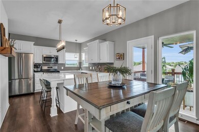 Dining room featuring sink, a chandelier, and dark wood-type flooring