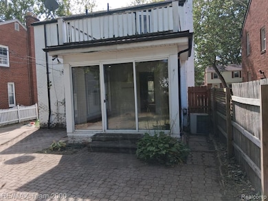 Back of property with a patio, a balcony, and brick siding