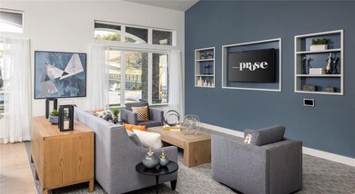 Living room featuring built in features and a towering ceiling