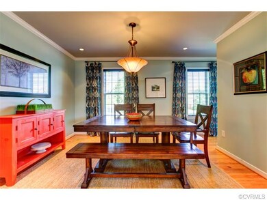 Dining room with lovely crown molding detail and r