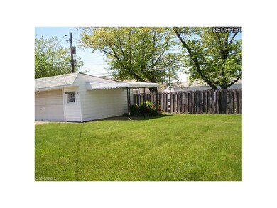 The backyard is extra wide with a privacy fence in