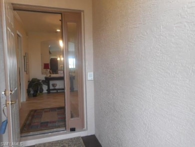 Doorway to property with stucco siding
