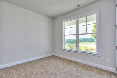 Empty room with baseboards, carpet, and plenty of natural light