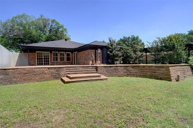 Rear view of property featuring a lawn