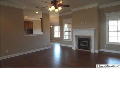 Family room seciond view, wood flooring, 10 ft ceiling, recessed lighting, fireplace.