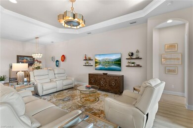 Living room featuring an inviting chandelier, a tr