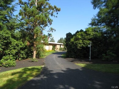 A circular driveway provides access to the propert