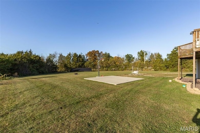 View of green lawn with view of wooded area