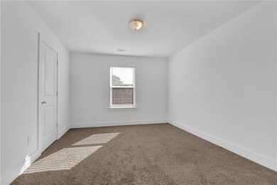 Carpeted empty room featuring baseboards and visib