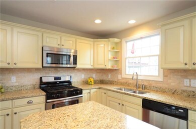 The kitchen offers granite countertops with a tile