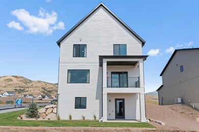 Rear view of property featuring a patio area, a balcony, and a mountain view