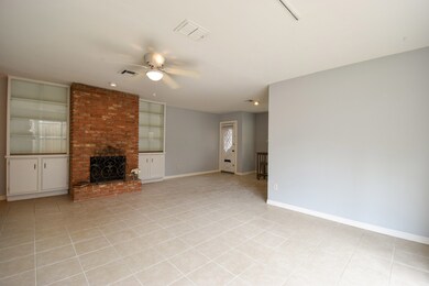 Large living area with built ins and fireplace