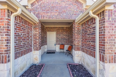 Entrance to property featuring brick siding