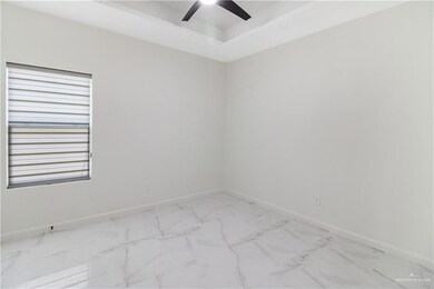 Unfurnished room featuring a wealth of natural light, tile flooring, and ceiling fan