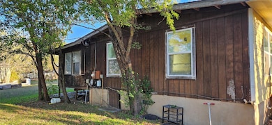 View of property exterior featuring a yard