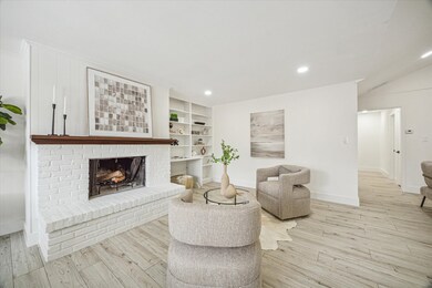 Anchored by a charming wood-burning fireplace, the