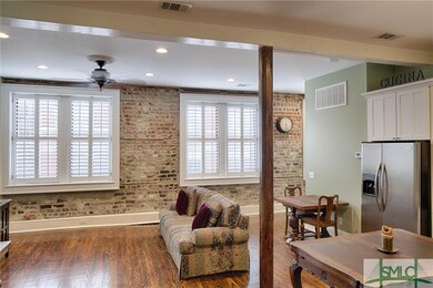 Open kitchen / living space , exposed brick walls,