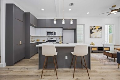 This modern kitchen boasts sleek cabinetry, stainl