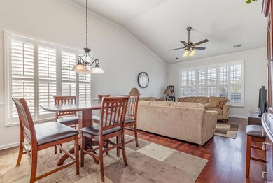 Dining room with crown molding, lofted ceiling, a 
