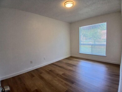 Empty room with dark wood finished floors, basebo