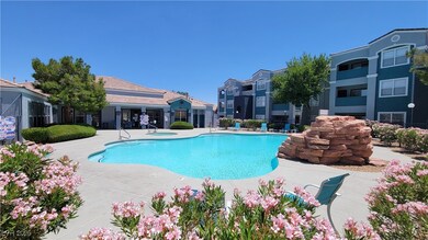Community pool featuring a hot tub and a patio